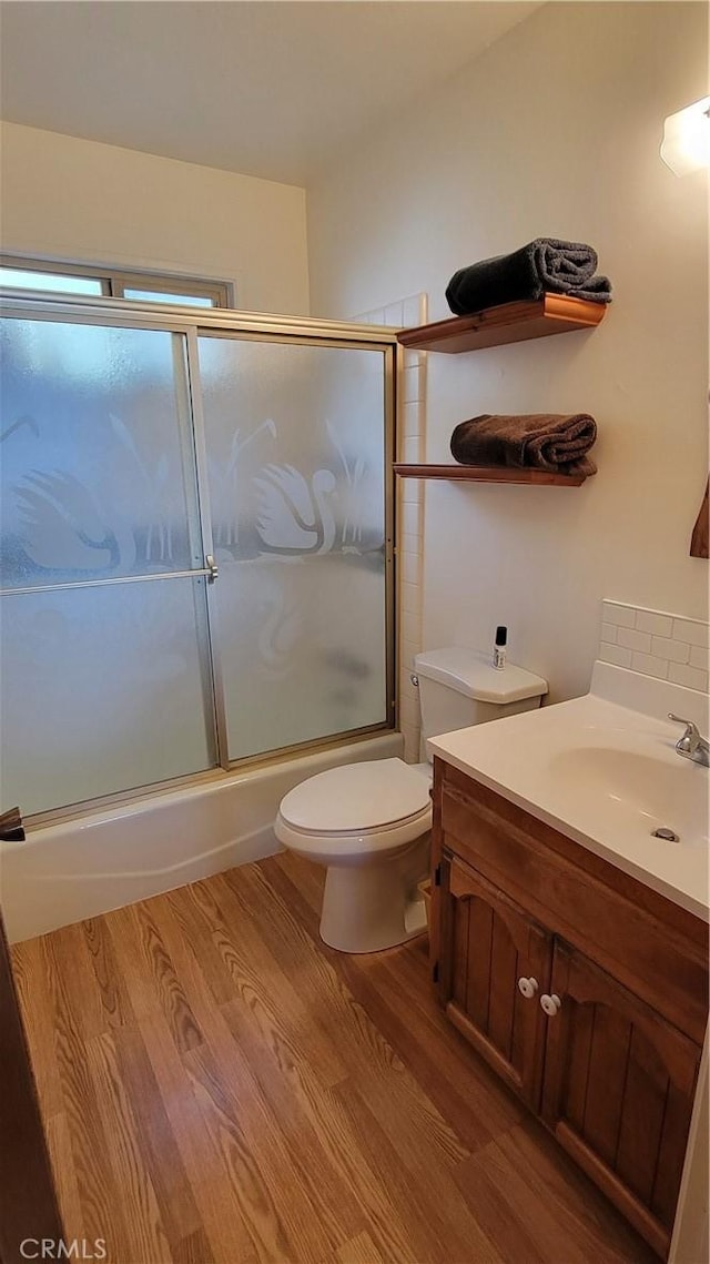 1239 Yosemite Dr, Lake Arrowhead, CA 92352 - full bathroom featuring wood finished floors, vanity, enclosed tub / shower combo, and toilet