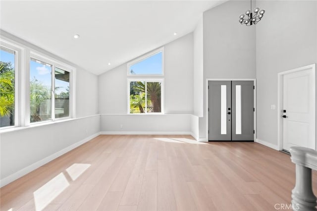 foyer featuring a chandelier, high vaulted ceiling, recessed lighting, baseboards, and light wood-type flooring