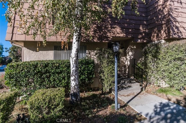 view of side of property featuring stucco siding