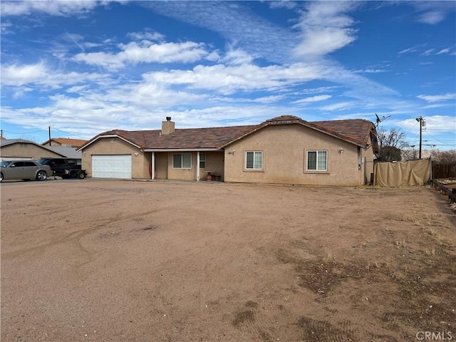 ranch-style home featuring a garage