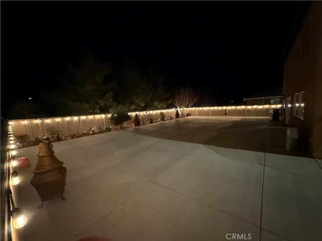 pool at twilight with a patio