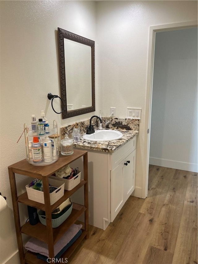 bathroom with hardwood / wood-style floors and vanity