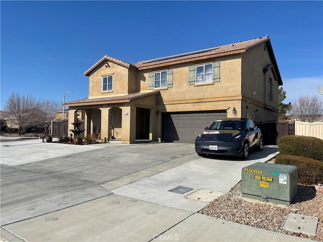 view of front of home featuring stucco siding, driveway, fence, an attached garage, and a tiled roof