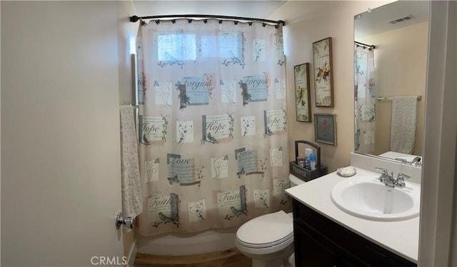 full bathroom with shower / tub combo, vanity, and toilet