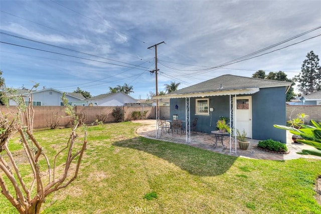 view of yard featuring a patio area and a fenced backyard