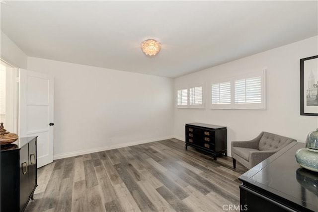 living room featuring light wood-style flooring and baseboards