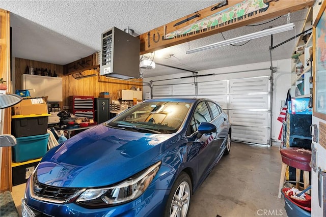 garage featuring wood walls