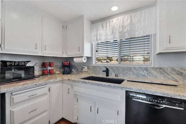 kitchen featuring sink, white cabinetry, and black appliances