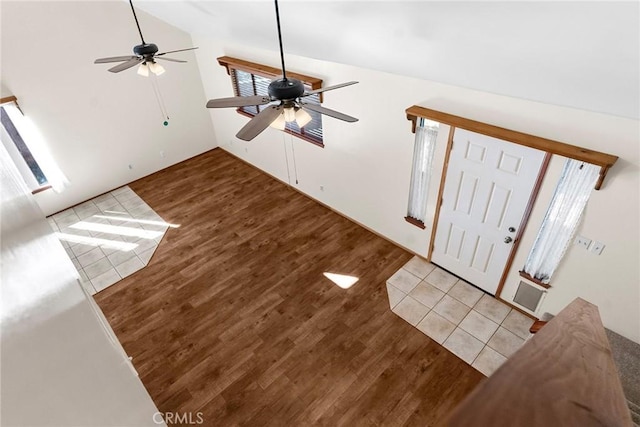 foyer entrance with lofted ceiling and wood finished floors