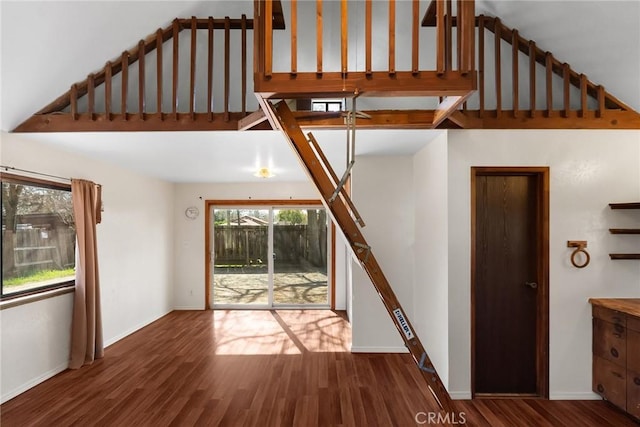 unfurnished living room with baseboards and wood finished floors