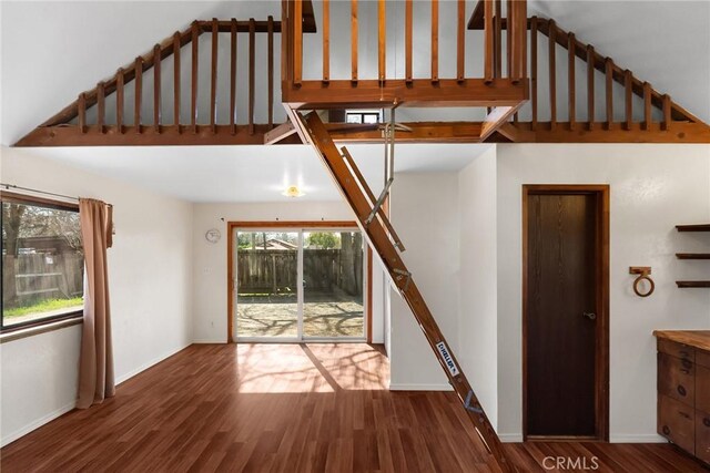 stairway featuring baseboards and wood finished floors