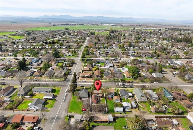 drone / aerial view featuring a residential view and a mountain view