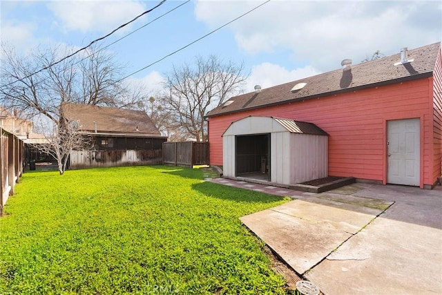 view of yard with a storage shed, a patio, an outbuilding, and a fenced backyard