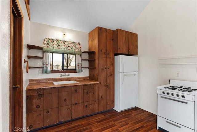 kitchen featuring white appliances, dark wood-style flooring, a sink, brown cabinets, and open shelves