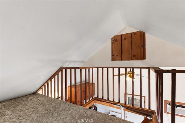 stairway featuring lofted ceiling