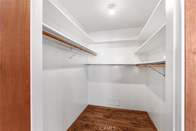 spacious closet featuring visible vents and wood finished floors