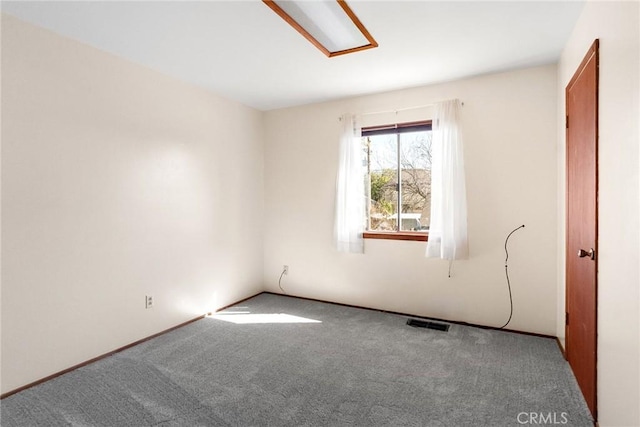 carpeted empty room featuring visible vents