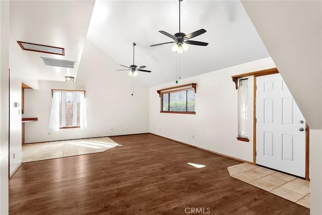 unfurnished living room with high vaulted ceiling, visible vents, ceiling fan, and wood finished floors