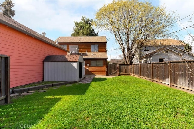 view of yard featuring a fenced backyard, an outbuilding, and a storage shed