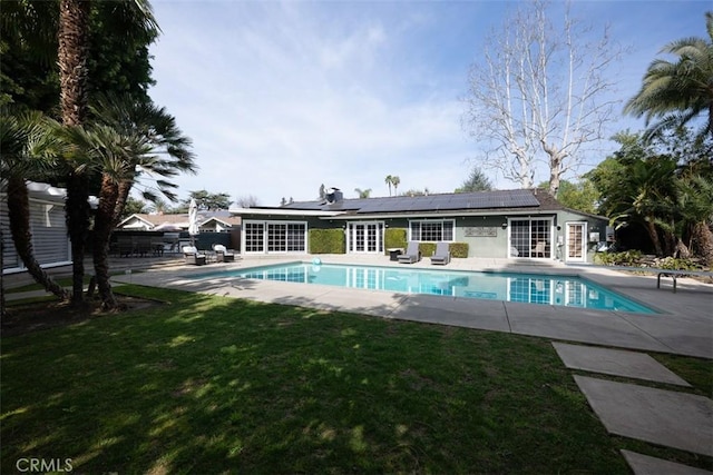 outdoor pool with a yard and a patio