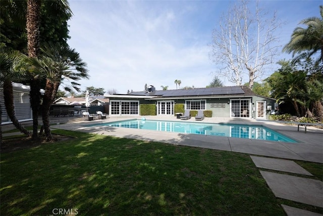 outdoor pool with a yard and a patio