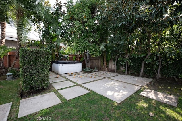 view of patio featuring a fenced backyard and a hot tub