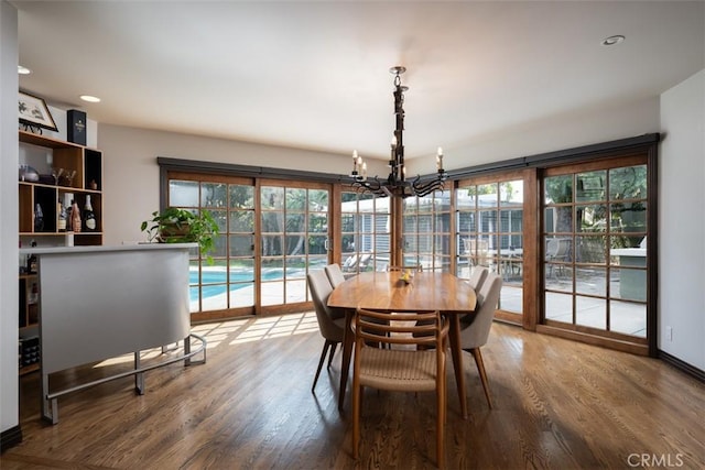 dining room featuring recessed lighting, a notable chandelier, and wood finished floors