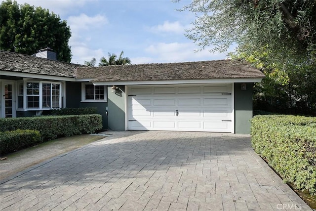 garage featuring decorative driveway