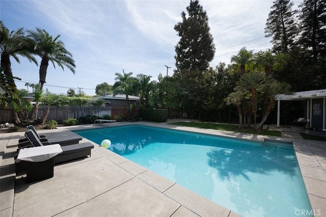 view of pool with a fenced in pool, a fenced backyard, a patio, and a diving board