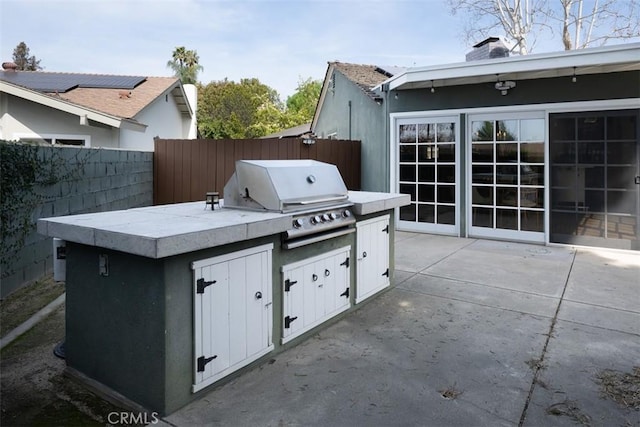 view of patio with grilling area, area for grilling, and a fenced backyard