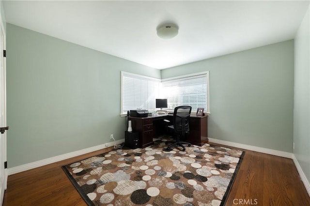 home office with baseboards and wood finished floors