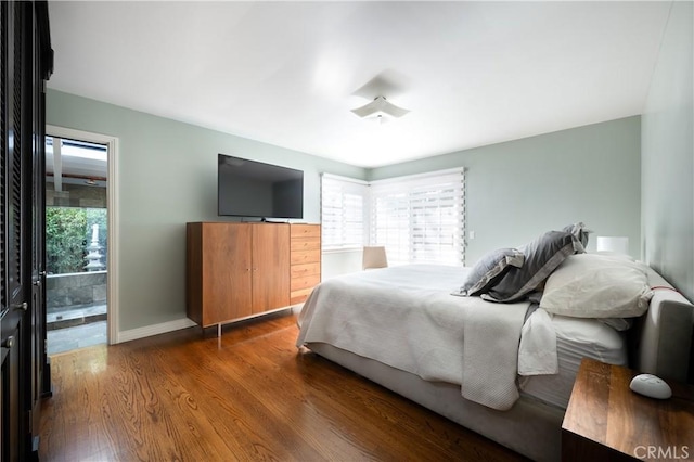 bedroom with wood finished floors and baseboards