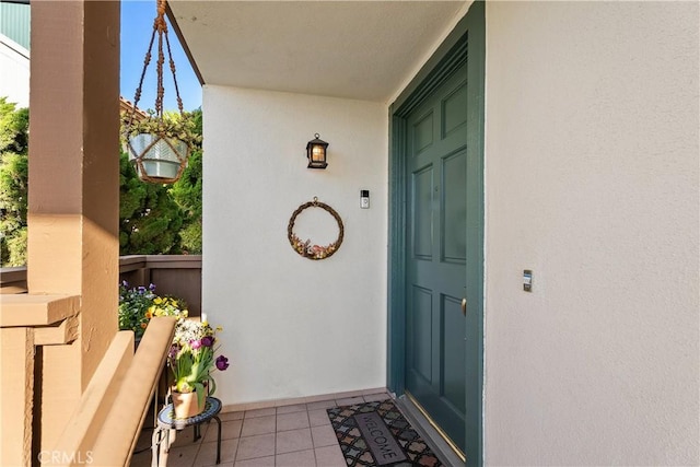 doorway to property featuring stucco siding