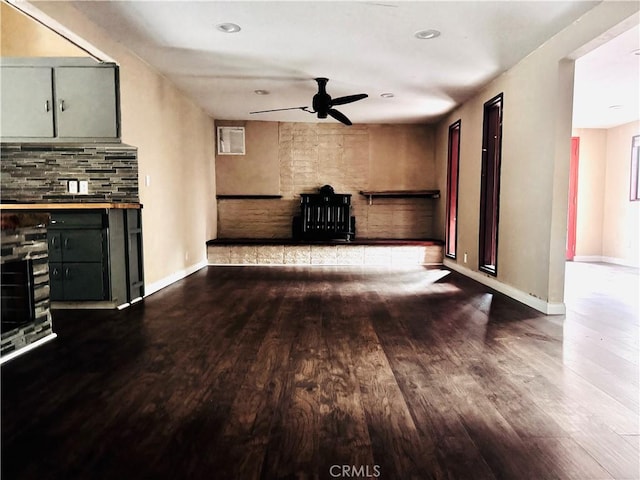 unfurnished living room featuring wine cooler, ceiling fan, wood-type flooring, and a fireplace