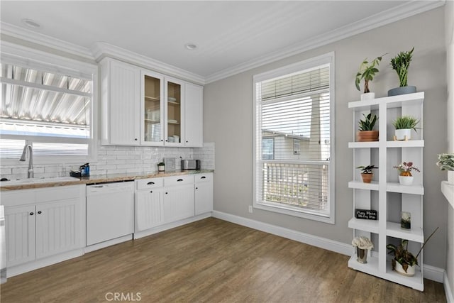 kitchen with white cabinetry, dishwasher, ornamental molding, and sink