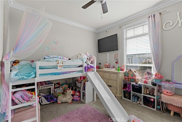 carpeted bedroom featuring crown molding and ceiling fan