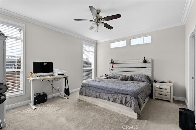 carpeted bedroom featuring ceiling fan and crown molding