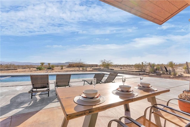 view of patio / terrace featuring a mountain view