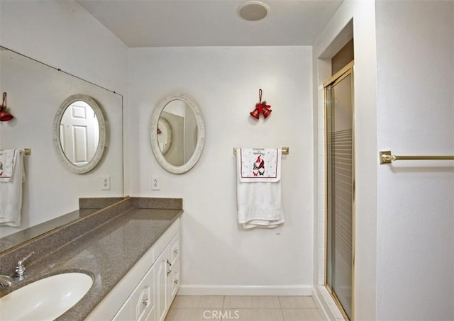 bathroom featuring tile patterned floors, vanity, and a shower with shower door