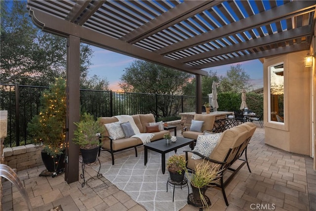 patio terrace at dusk with a fenced backyard and an outdoor living space