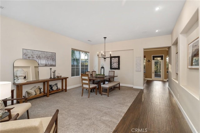 dining room featuring recessed lighting, an inviting chandelier, wood finished floors, and baseboards