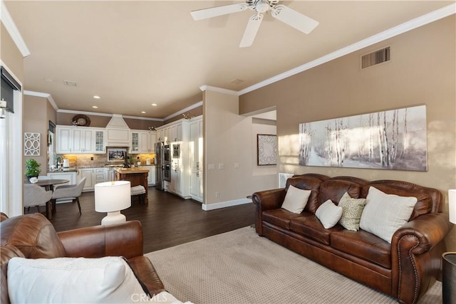 living room featuring dark wood finished floors, recessed lighting, visible vents, ornamental molding, and baseboards