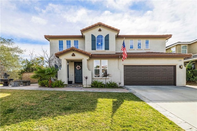 mediterranean / spanish home with concrete driveway, a front yard, a tiled roof, and stucco siding