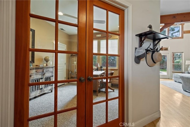 entryway featuring baseboards, visible vents, wood finished floors, and french doors