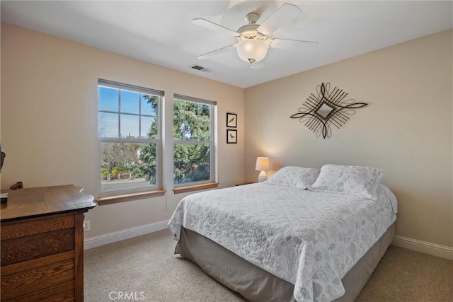 bedroom with light colored carpet, visible vents, and baseboards