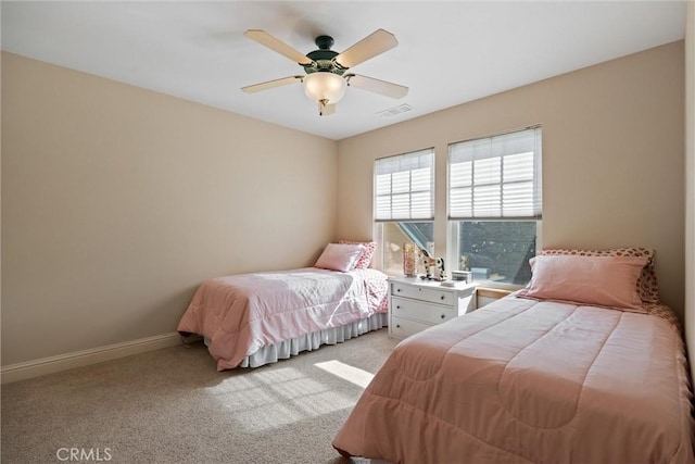 bedroom featuring baseboards, visible vents, a ceiling fan, and light colored carpet