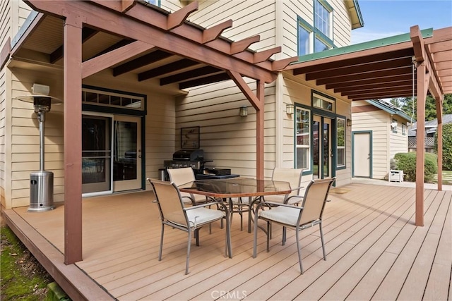 deck with outdoor dining space and grilling area