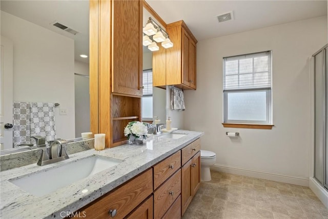 full bathroom featuring double vanity, baseboards, visible vents, and a sink