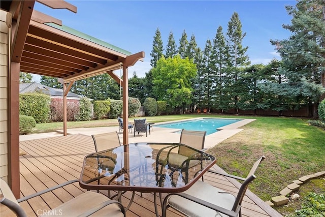 view of swimming pool with outdoor dining area, a fenced backyard, a yard, a wooden deck, and a fenced in pool