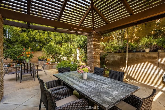 view of patio featuring outdoor dining space, fence, and a pergola